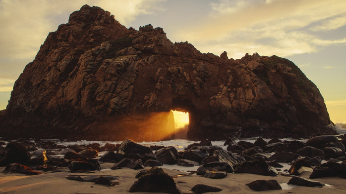 Sunset glowing through rock formation on Pfeiffer Beach, Big Sur, California, USA (700x393, 303Kb)