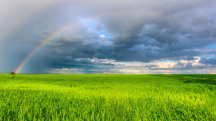 Double rainbow in the blue cloudy sky over field illuminated by the sun in the countryside (700x393, 395Kb)