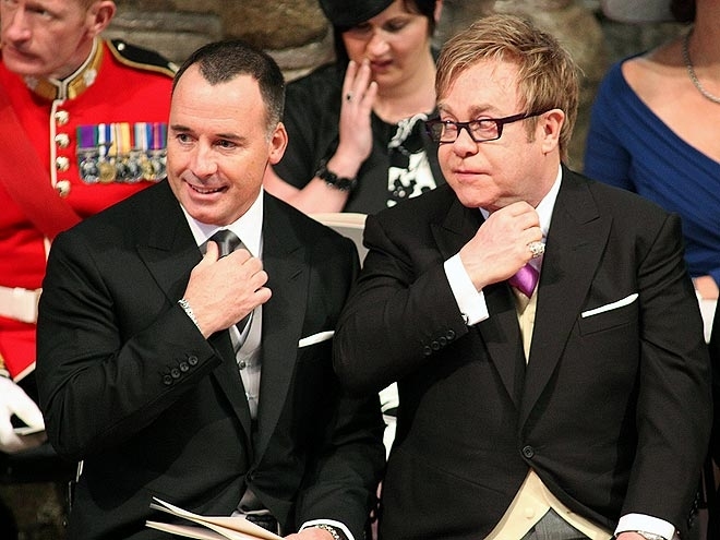 Singer Elton John and his partner David Furnish (L) wait after taking their seats for the Royal wedding of Prince William and Kate Middleton at Westminster Abbey in London April 29, 2011. REUTERS/Jon Bond/POOL  (BRITAIN - Tags: SPORT SOCCER ROYALS ENTERTA