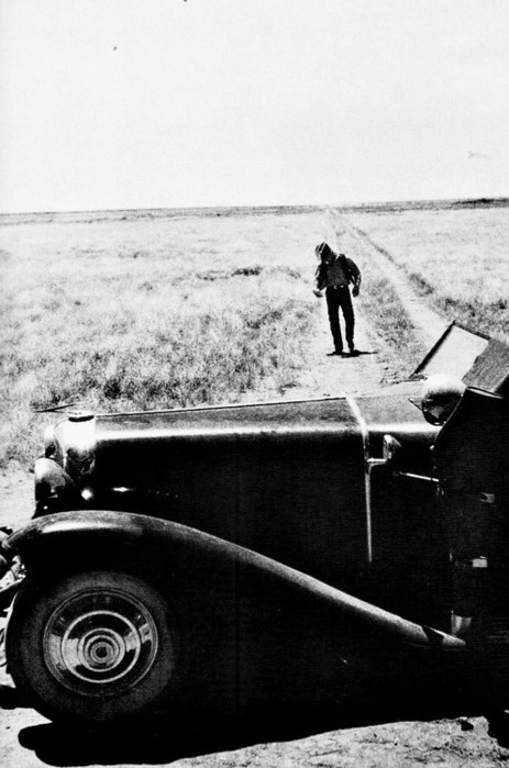 James Dean walking down a road from nowhere on the set of ''Giant'', 1955