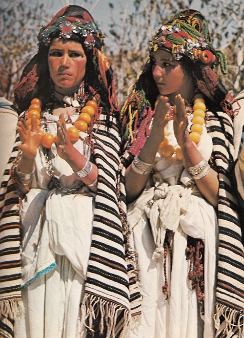 Berber girls clap to the rhythm of village musicians at a festival in the Atlas Mountains. The distinctively striped wool shawls they wear identify their clan affiliation (500x692, 197Kb)
