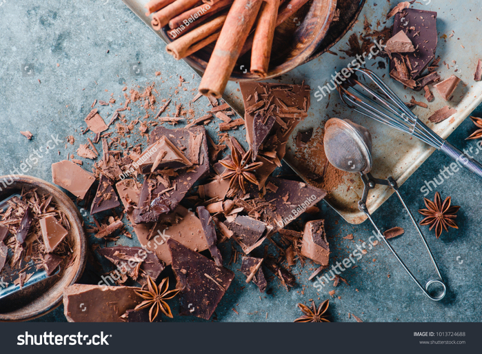 stock-photo-broken-dark-chocolate-cinnamon-and-anise-stars-on-a-concrete-background-with-a-cocoa-strainer-and-1013724688 (700x513, 592Kb)