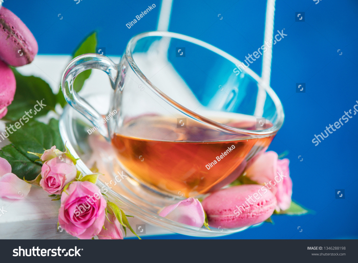 stock-photo-rose-tea-with-macaron-cookies-and-pink-flowers-on-swings-in-motion-spring-energy-concept-on-a-1346288198 (700x513, 392Kb)